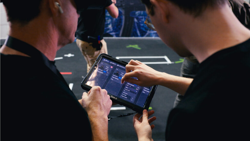 Image of two law enforcement instructors reviewing vr training session.